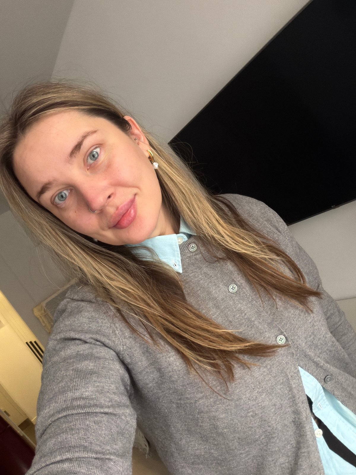 Woman in light blue shirt observed resting indoors Moscow
