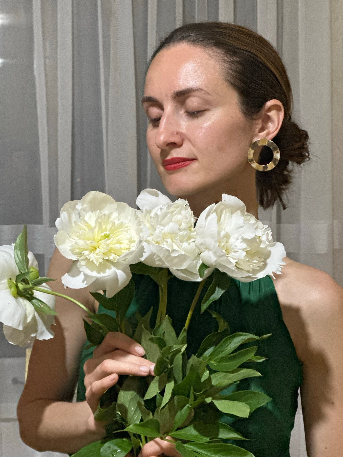 Woman poses with white peonies in Kryvyi Rih