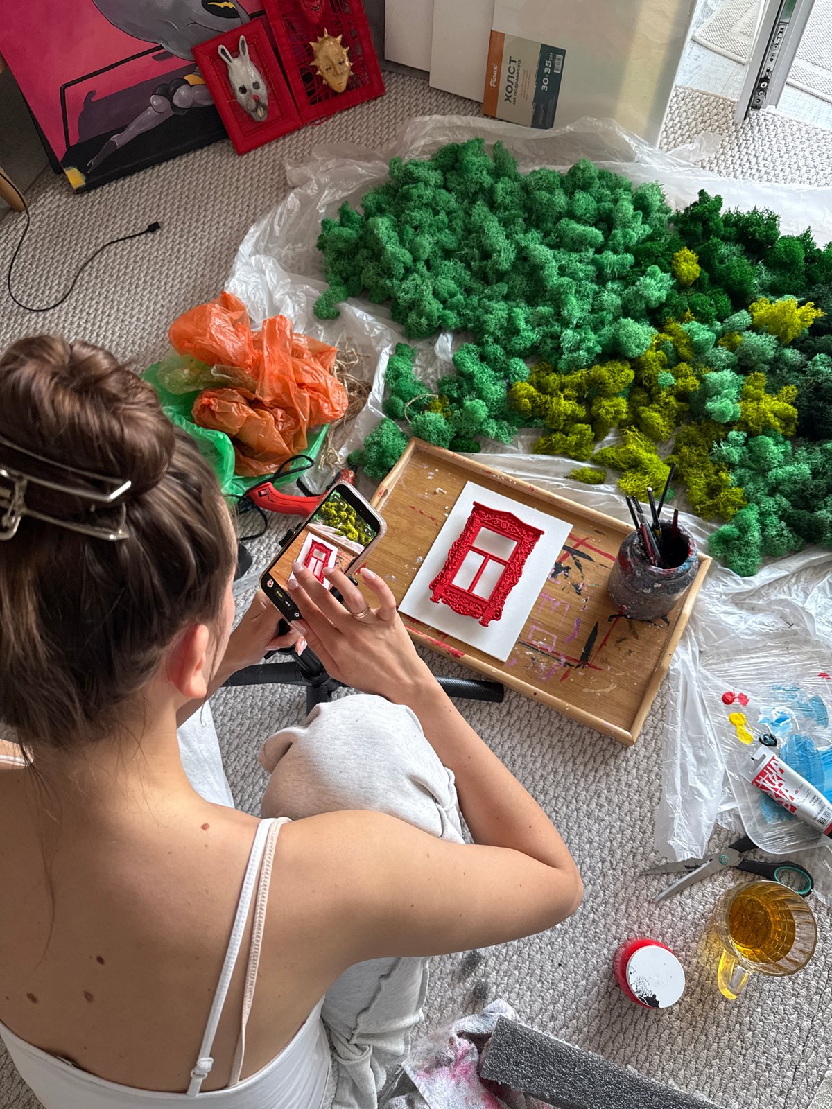 Artist documents craft project with smartphone in Krasnoyarsk