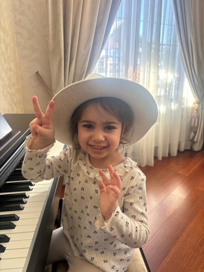 Young girl enjoys piano practice and snow play in Russian village