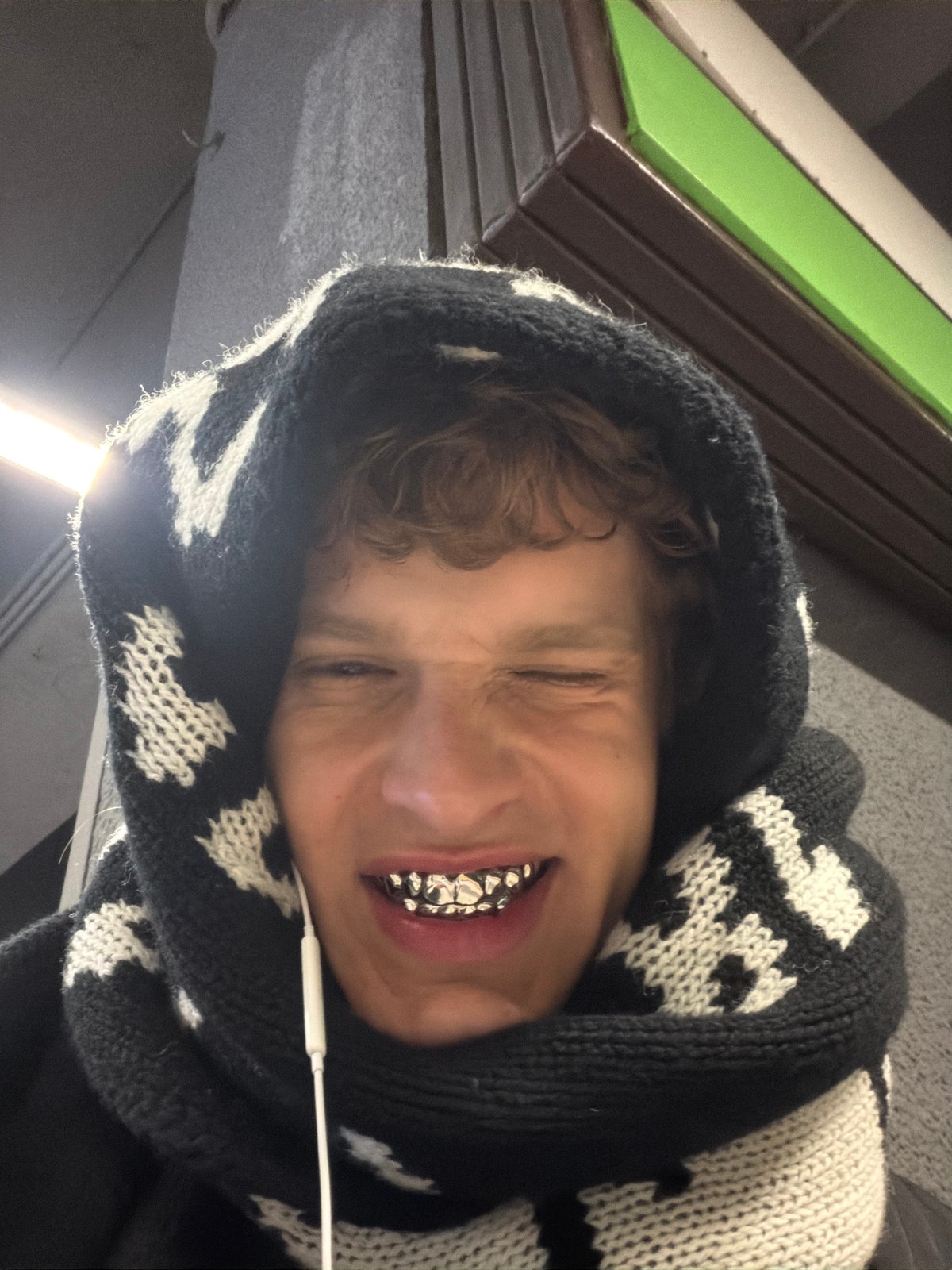 Portrait of young person in patterned hoodie captured in Milan