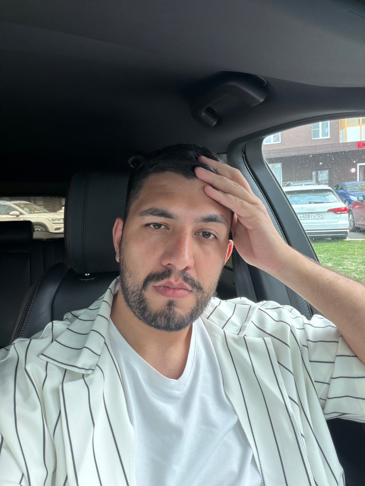 Parked in Krasnoyarsk, hand to forehead in the driver's seat