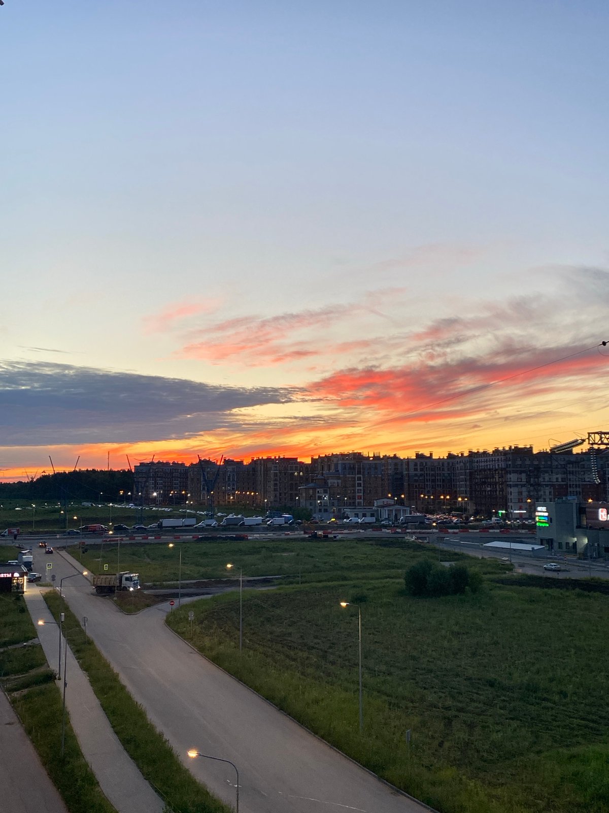 City skyline glows under a vivid dusk sunset