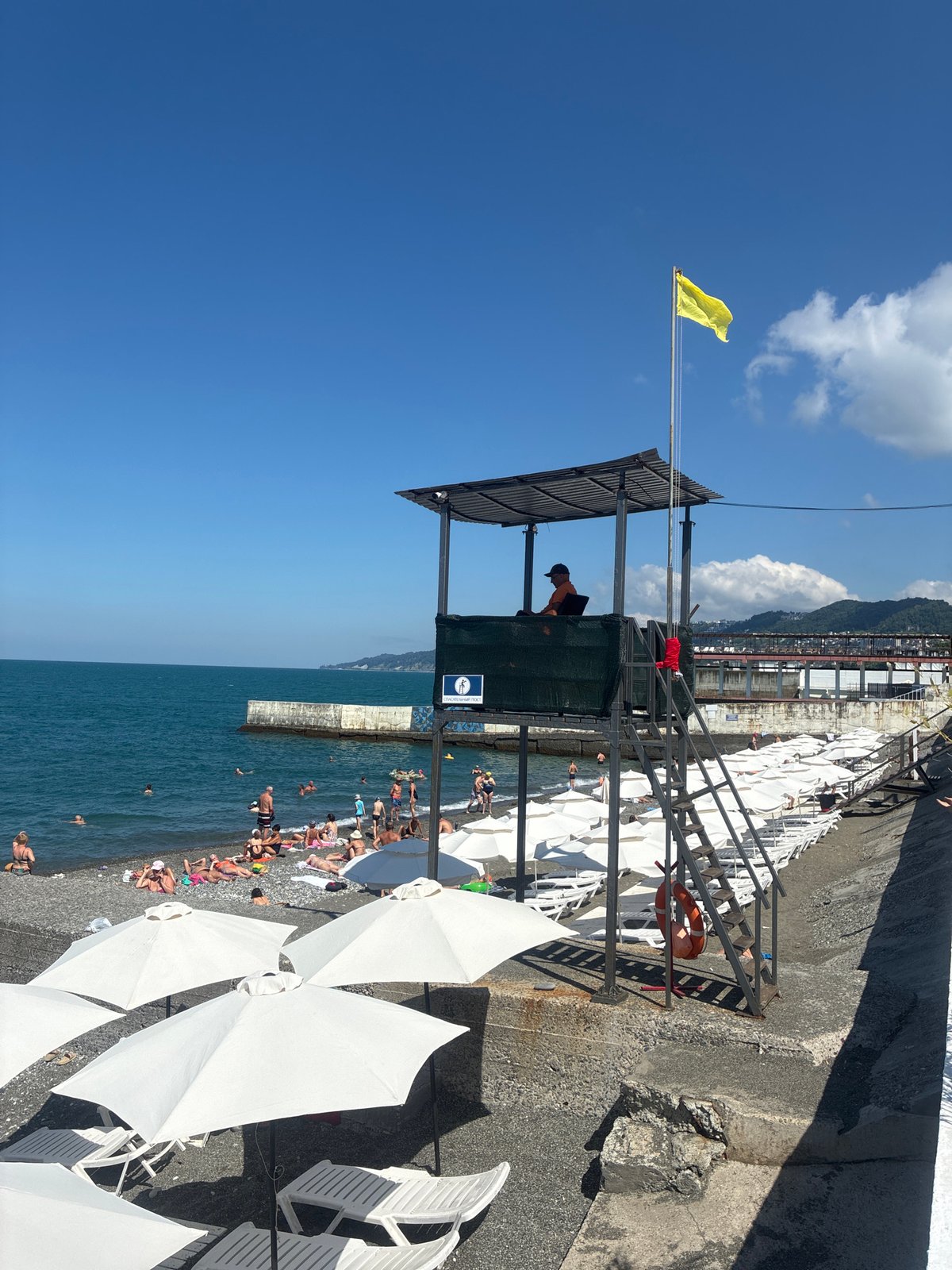 Crowded summer beach day on Sochi's pebble shore