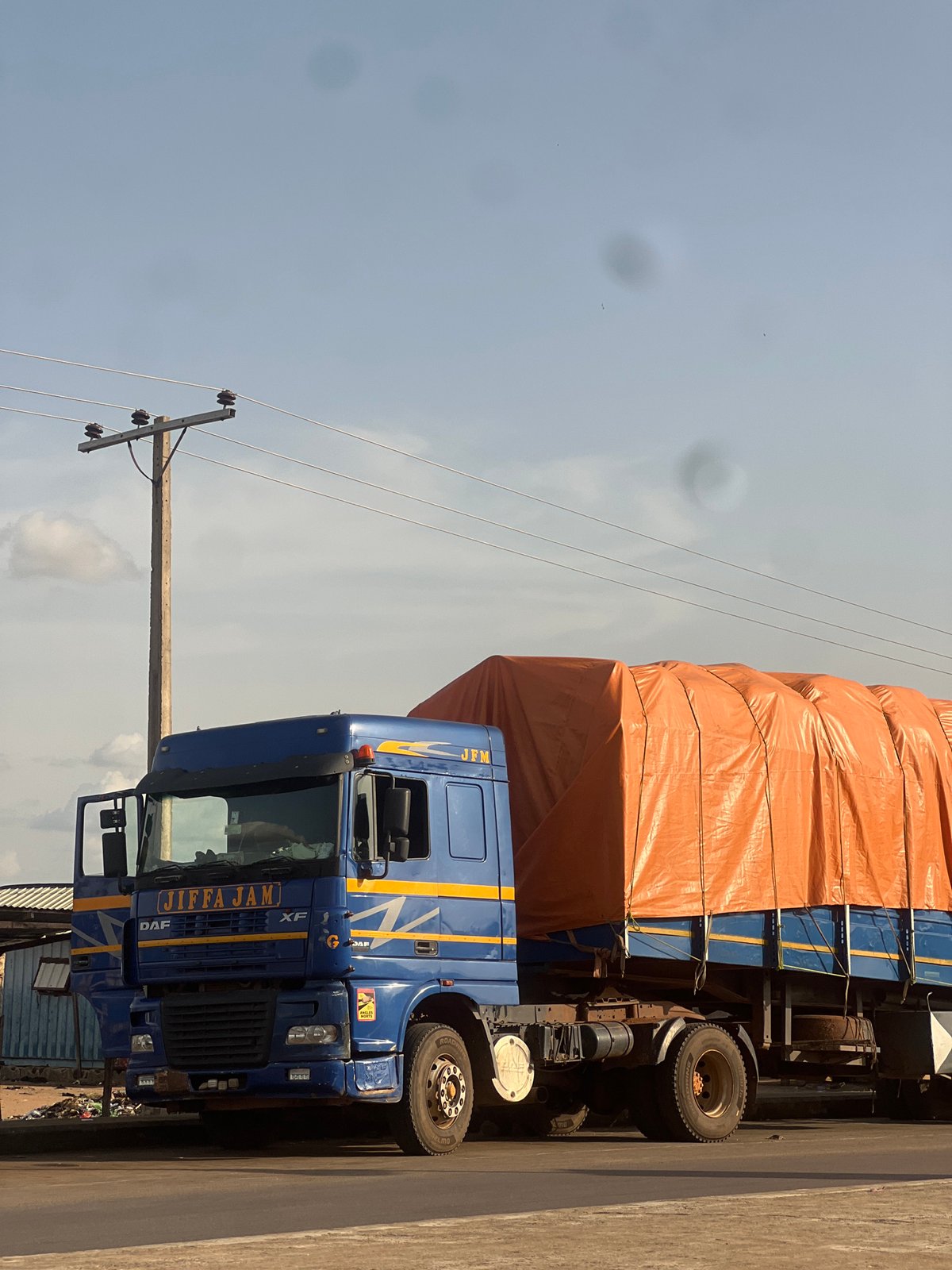 Commercial roadside strip in Jalingo, Nigeria, mid-afternoon