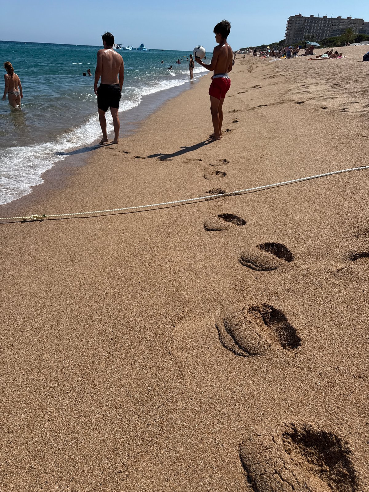A summer afternoon across Blanes beach and its boardwalk