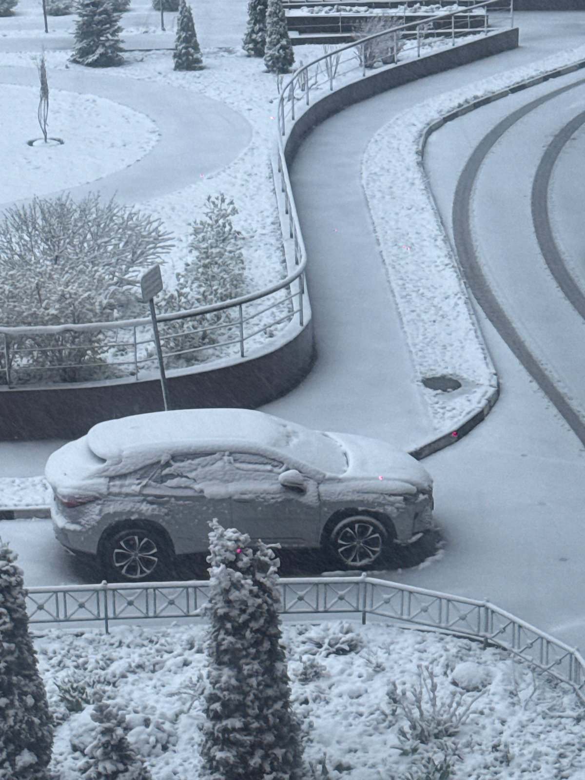 Heavy spring snowfall blankets Khimki, Russia streets and buildings