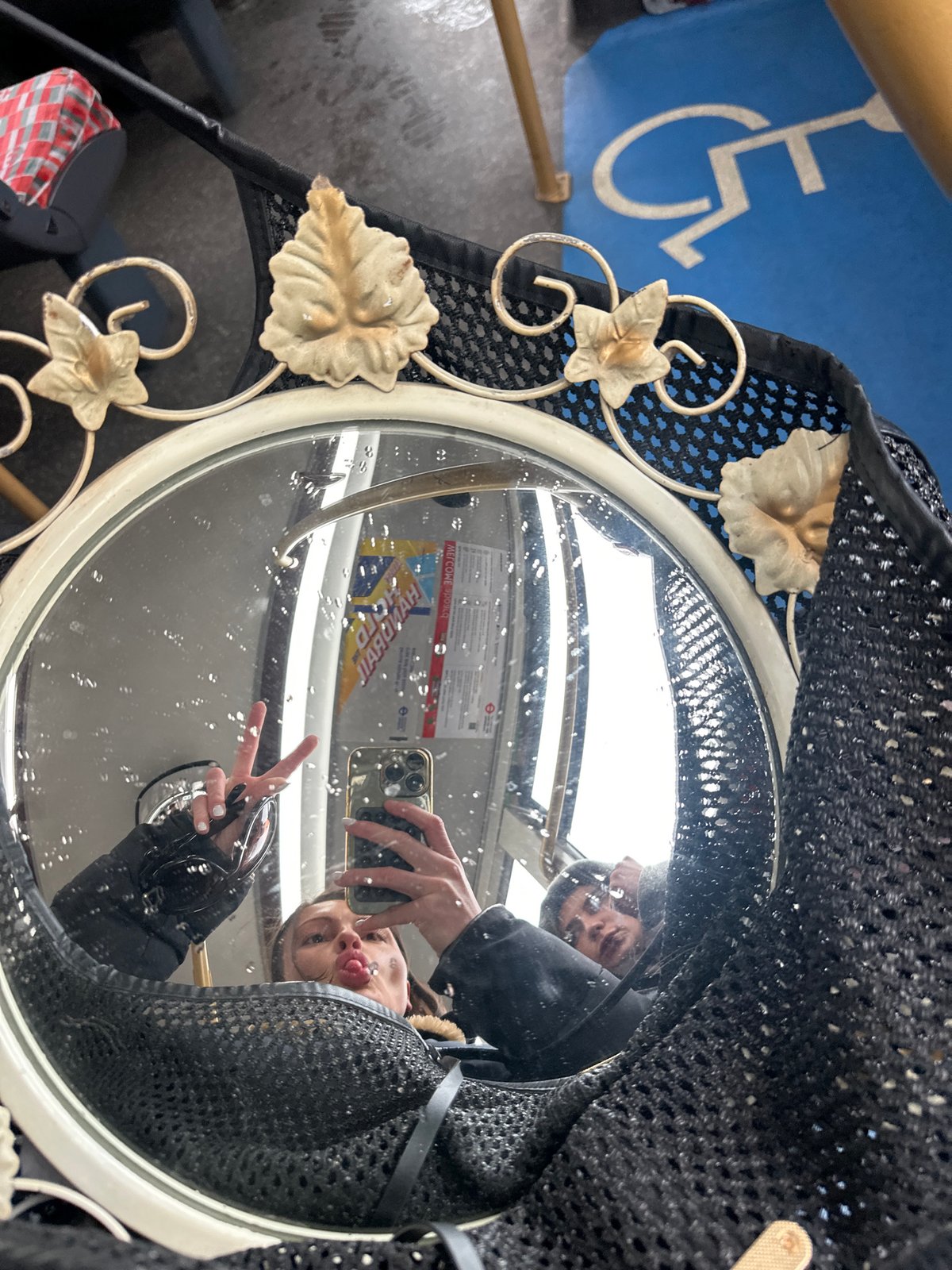 Person takes mirror selfie with peace sign in London