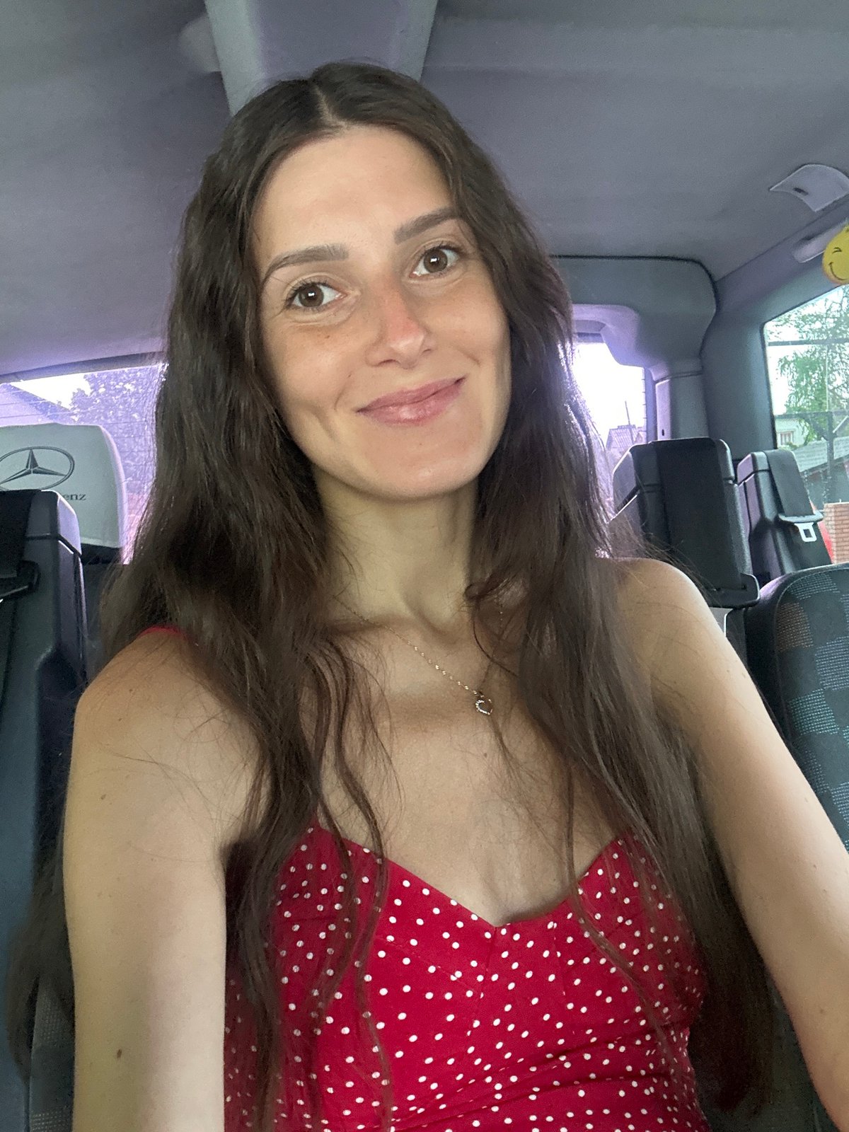 Woman in polka-dot dress photographed in vehicle, Wisła