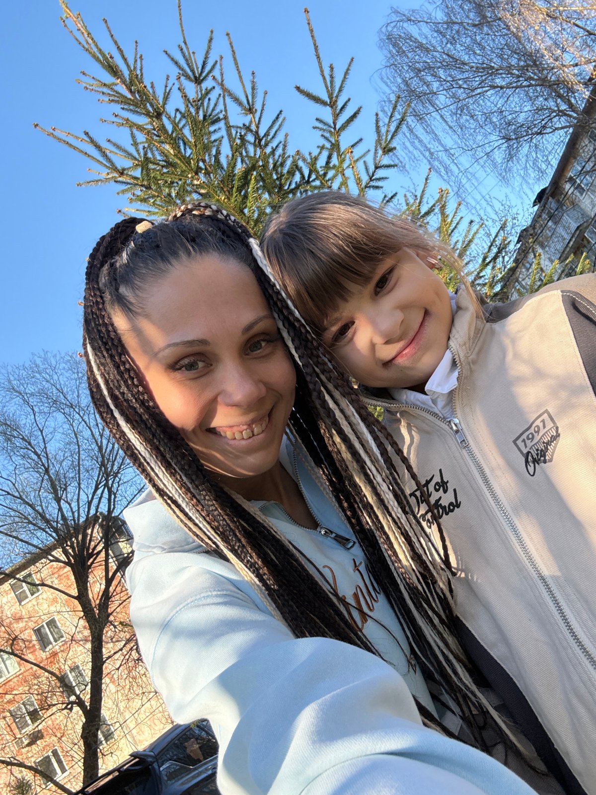 Woman and child enjoy sunny afternoon selfies in Rusanovo