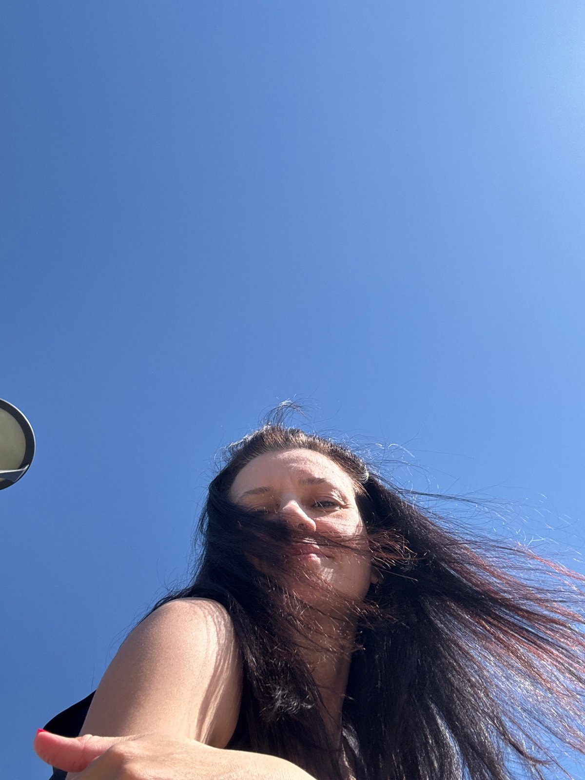 Windblown portrait captured against blue sky in Chaikovsky