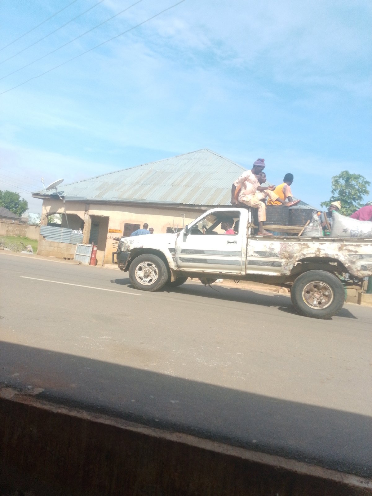 Morning street life along a paved road in Tempure, Nigeria