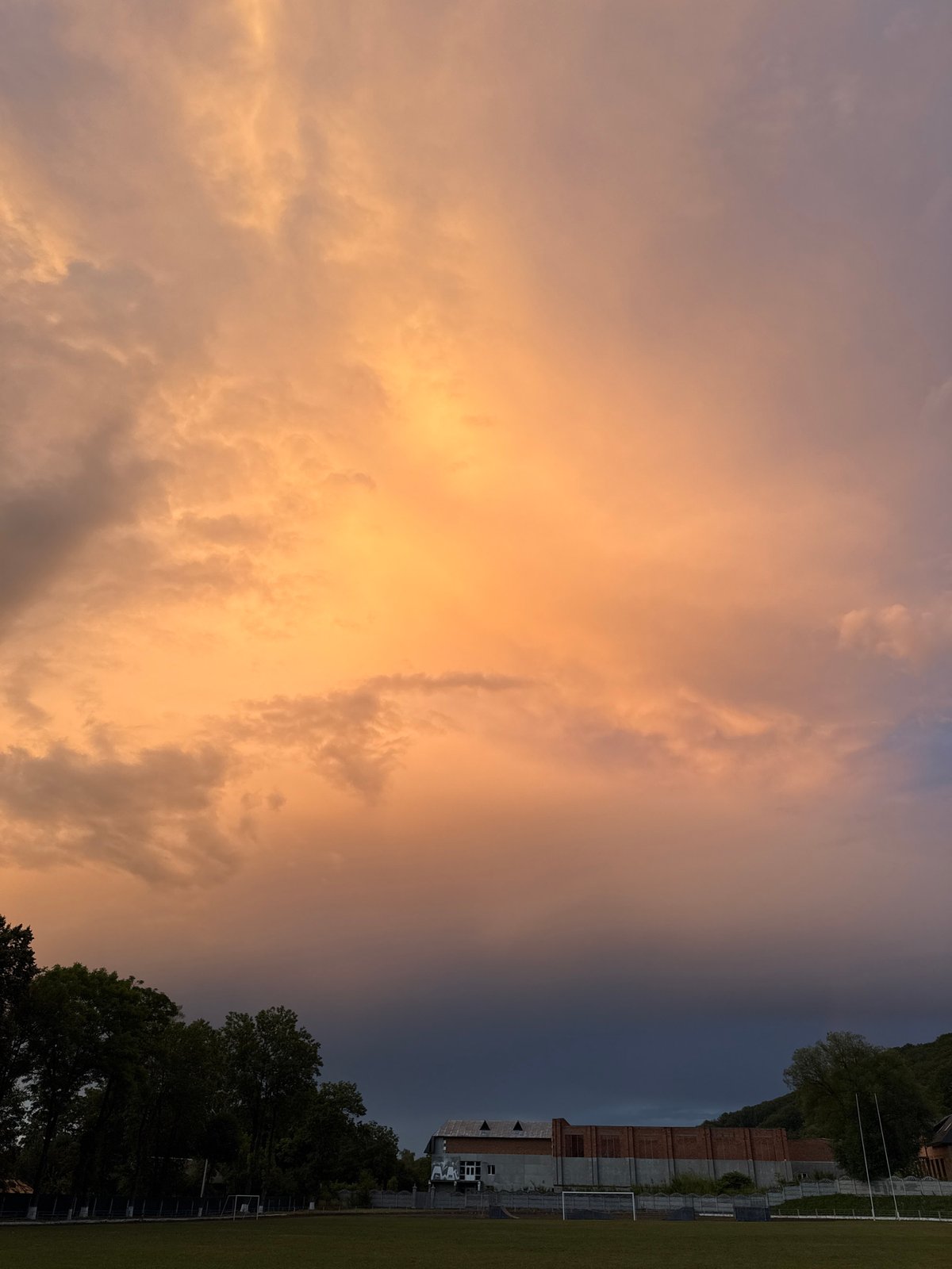 Sunset clouds over a forested stadium, multiple angles