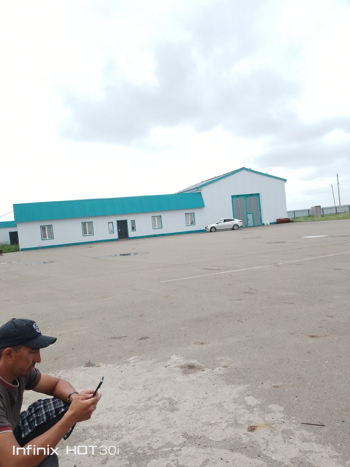 Phone break in an outdoor industrial yard on an overcast day