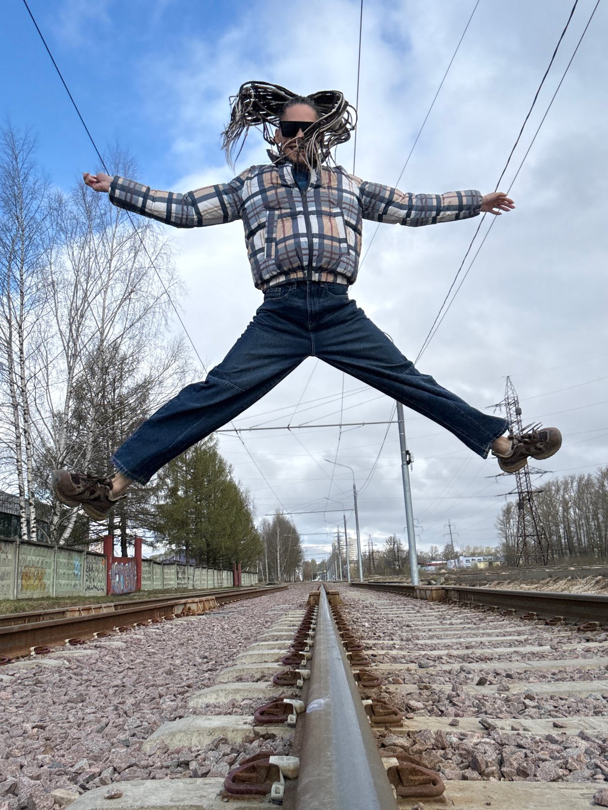 Person poses on railway tracks in Rusanovo, Russia