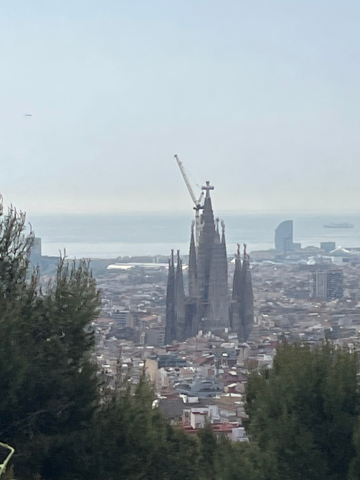 Barcelona panoramic view captured showing Sagrada Familia under hazy skies