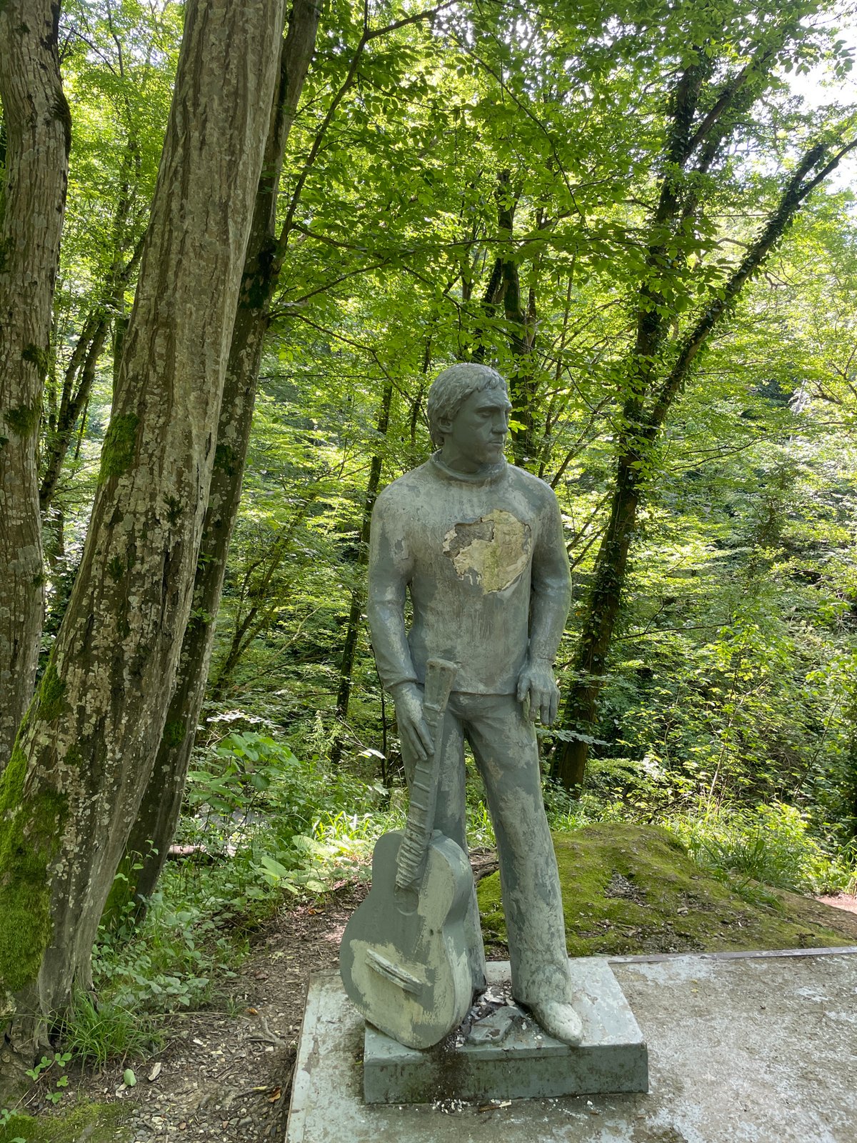 Family explores forest statue memorial in Khostinskiy, Russia