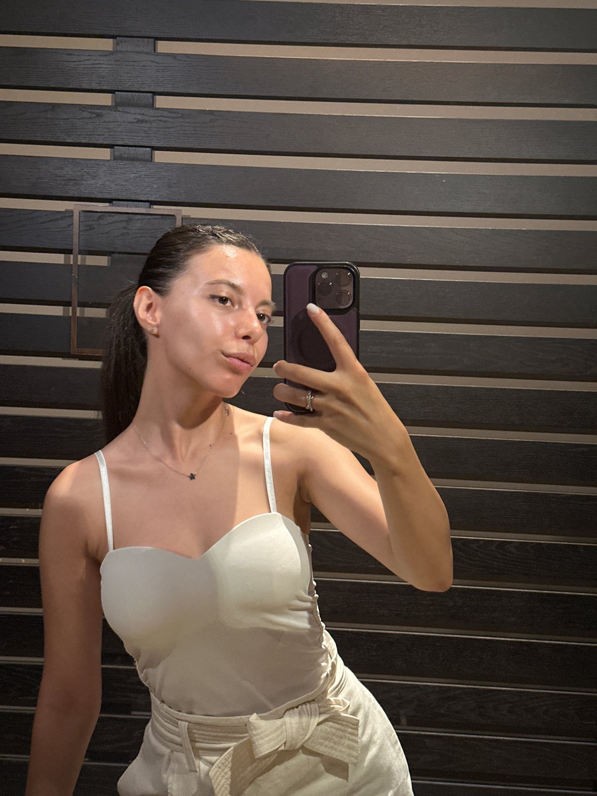 Back-to-back mirror selfies in a Pravets building, both all-white looks