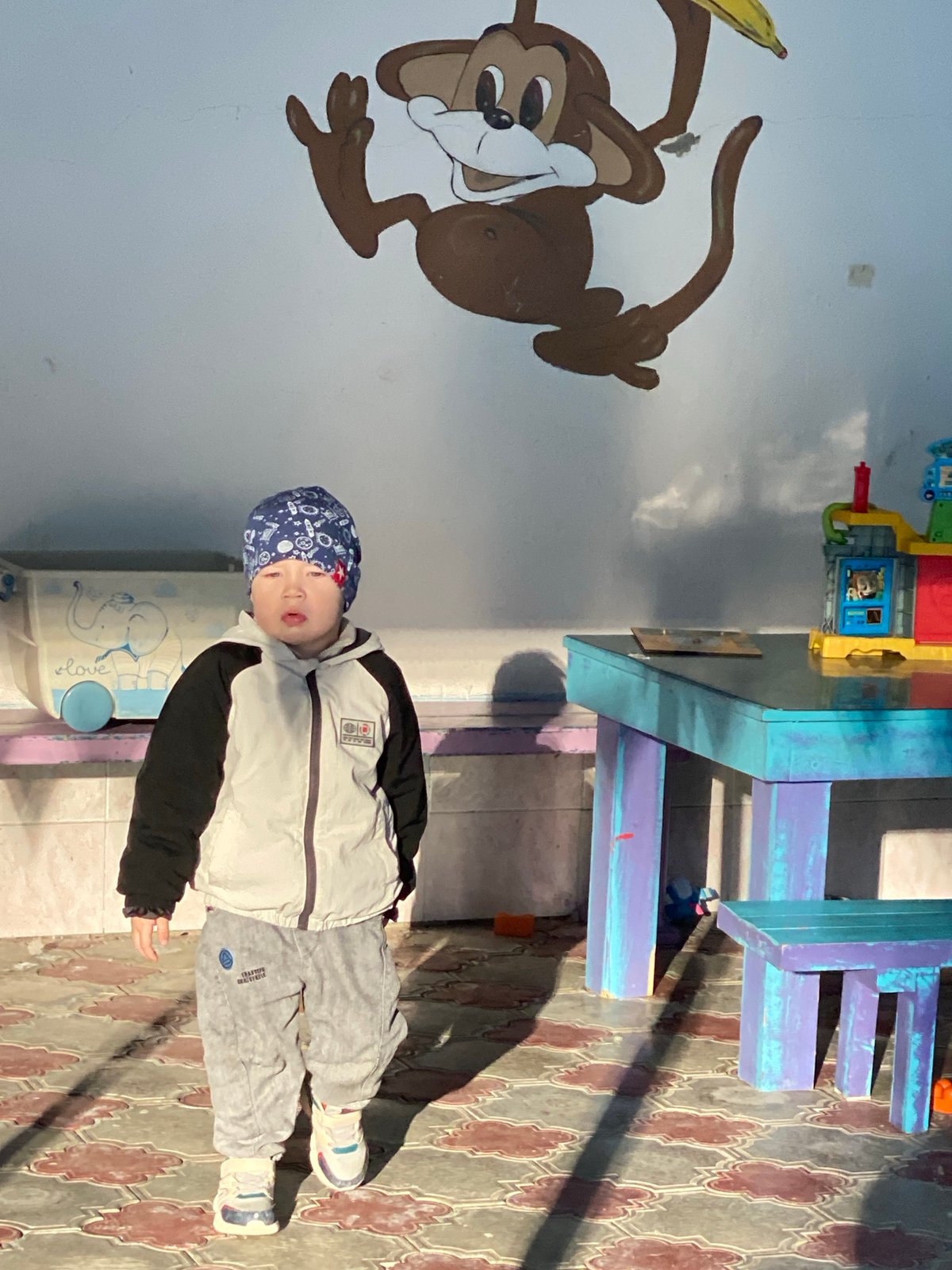 Child plays at indoor facility, walks stairs in Sochi