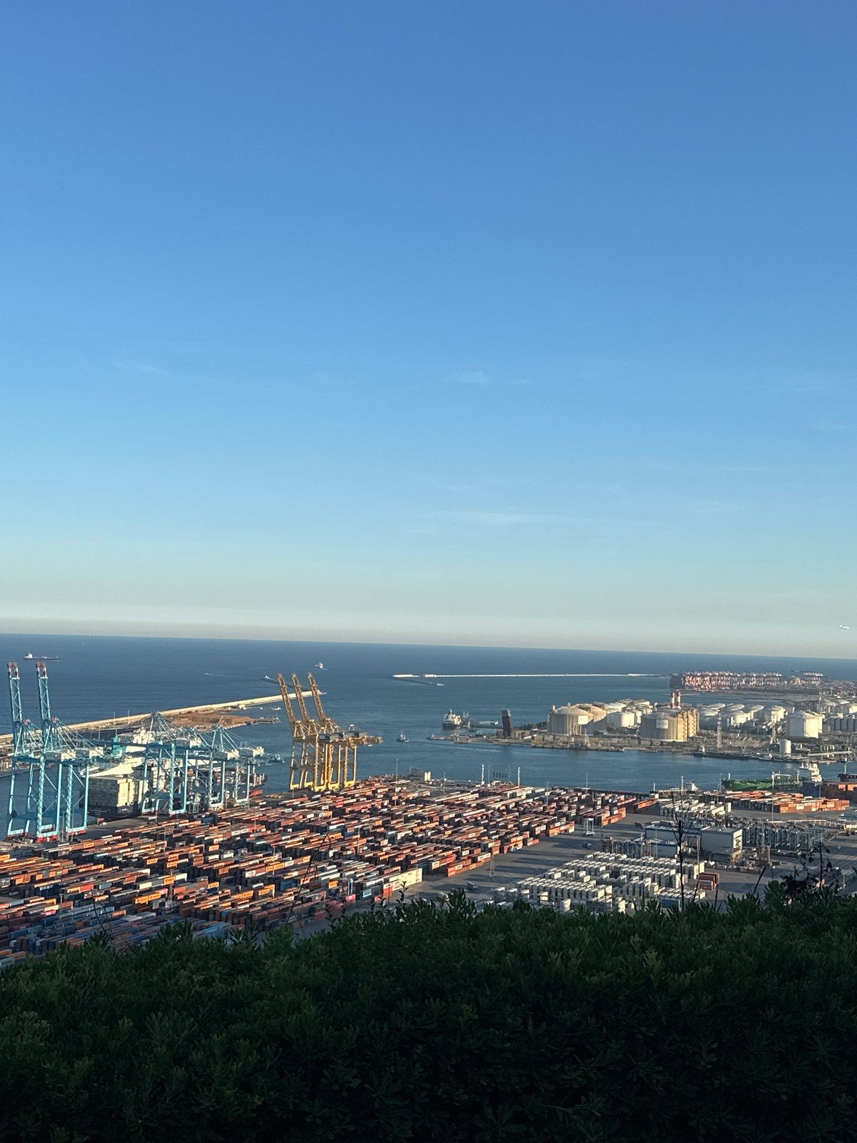 Aerial view captures Barcelona port activity under clear skies