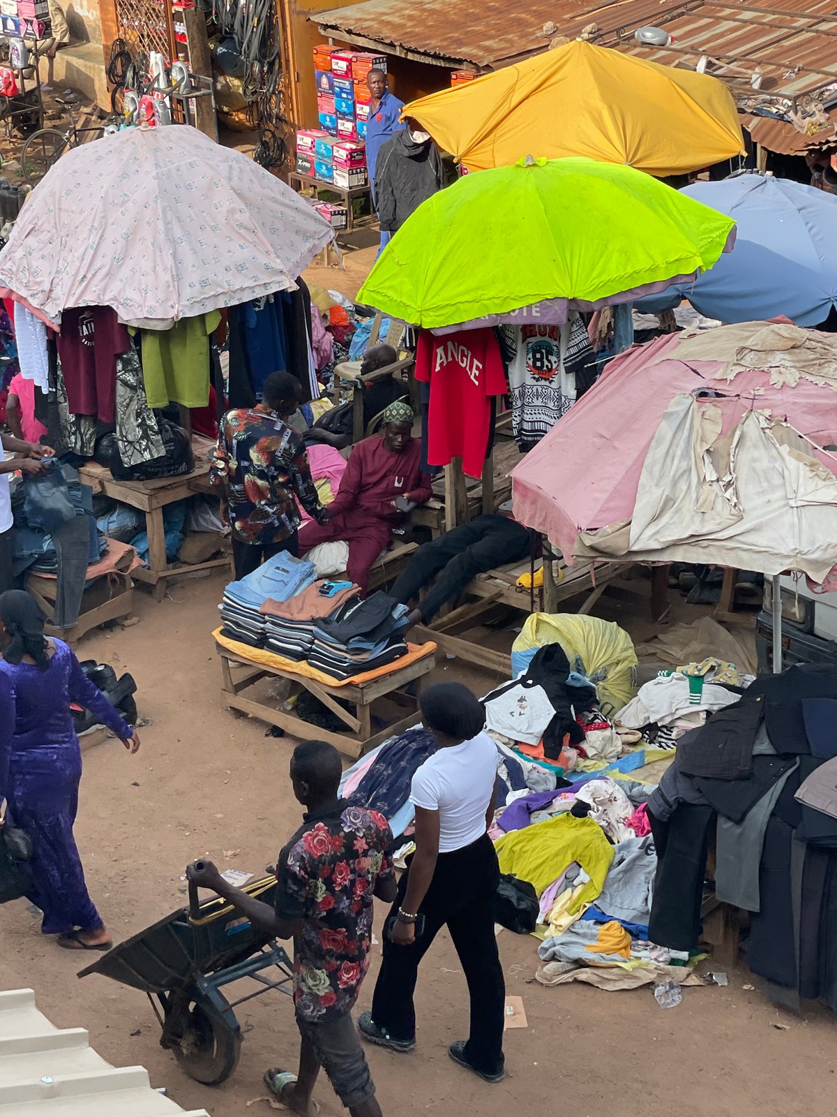 Busy outdoor clothing market draws crowds in unidentified city