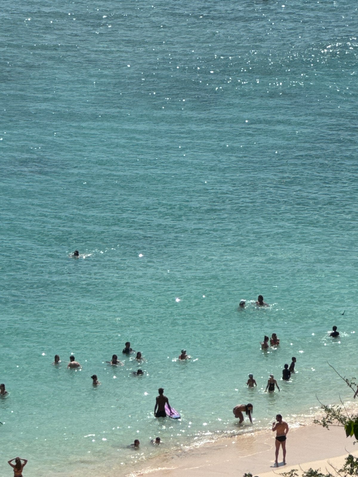 Crowded beach day at Kuta Selatan, surf lessons and all