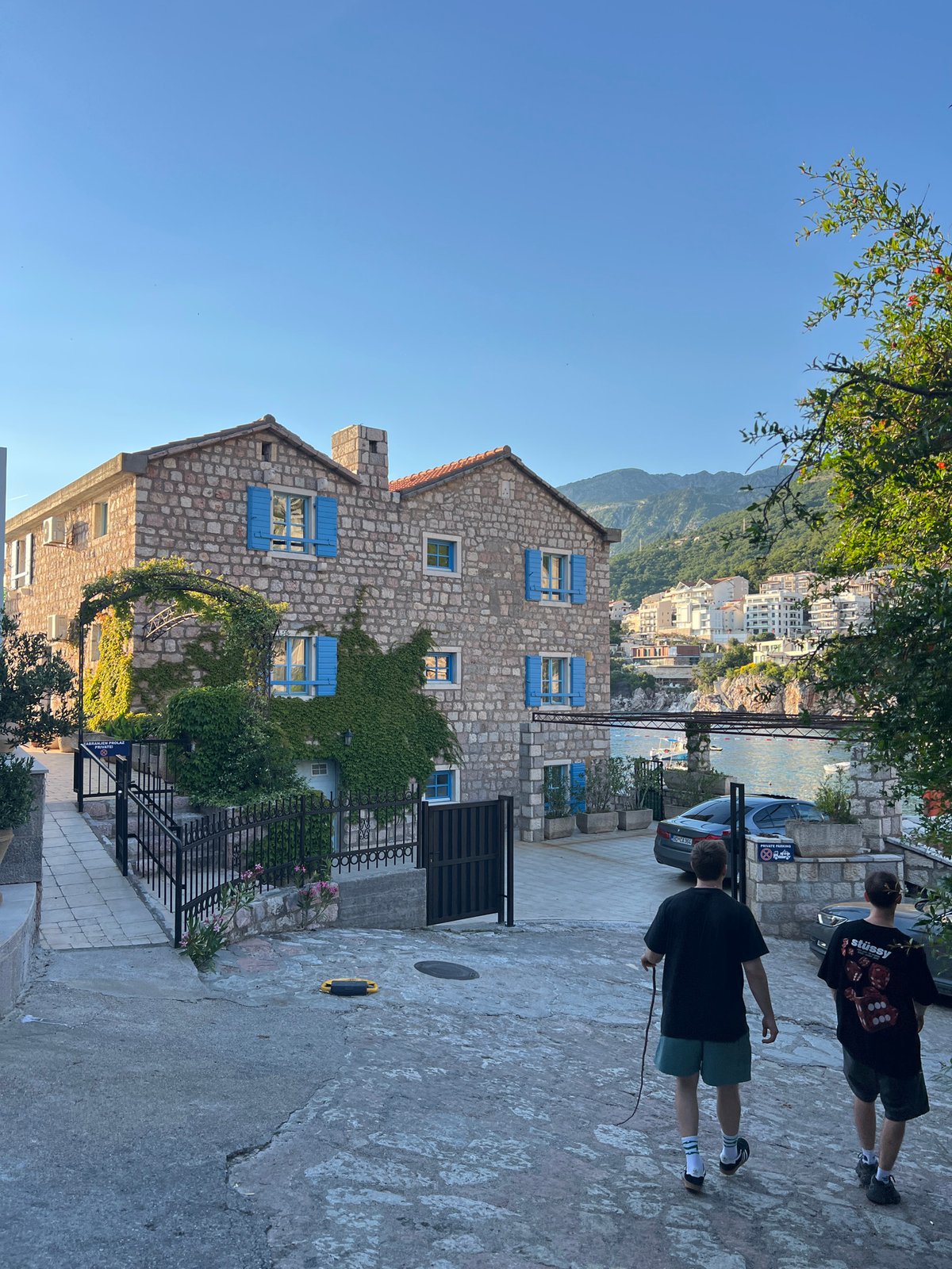 Stone building with blue shutters observed in Pržno, Montenegro
