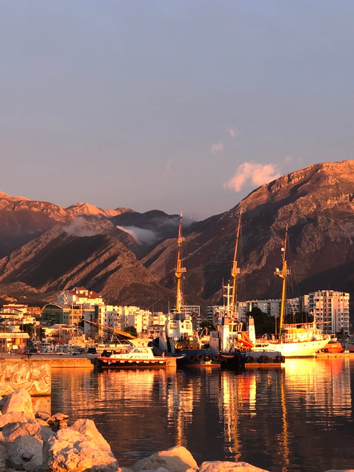 Tourists enjoy sunset harbor activities in Bar, Montenegro