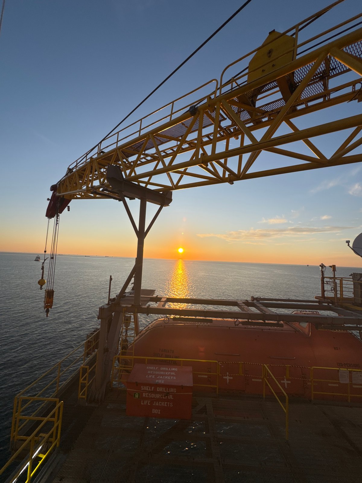 Offshore worker documents sunset from Italian industrial platform