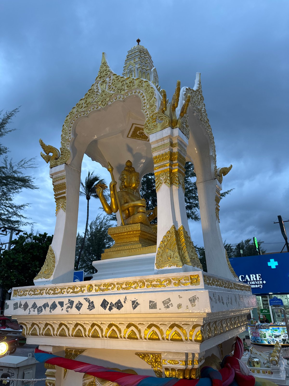 Elaborate gold spirit house shrine on a Patong street