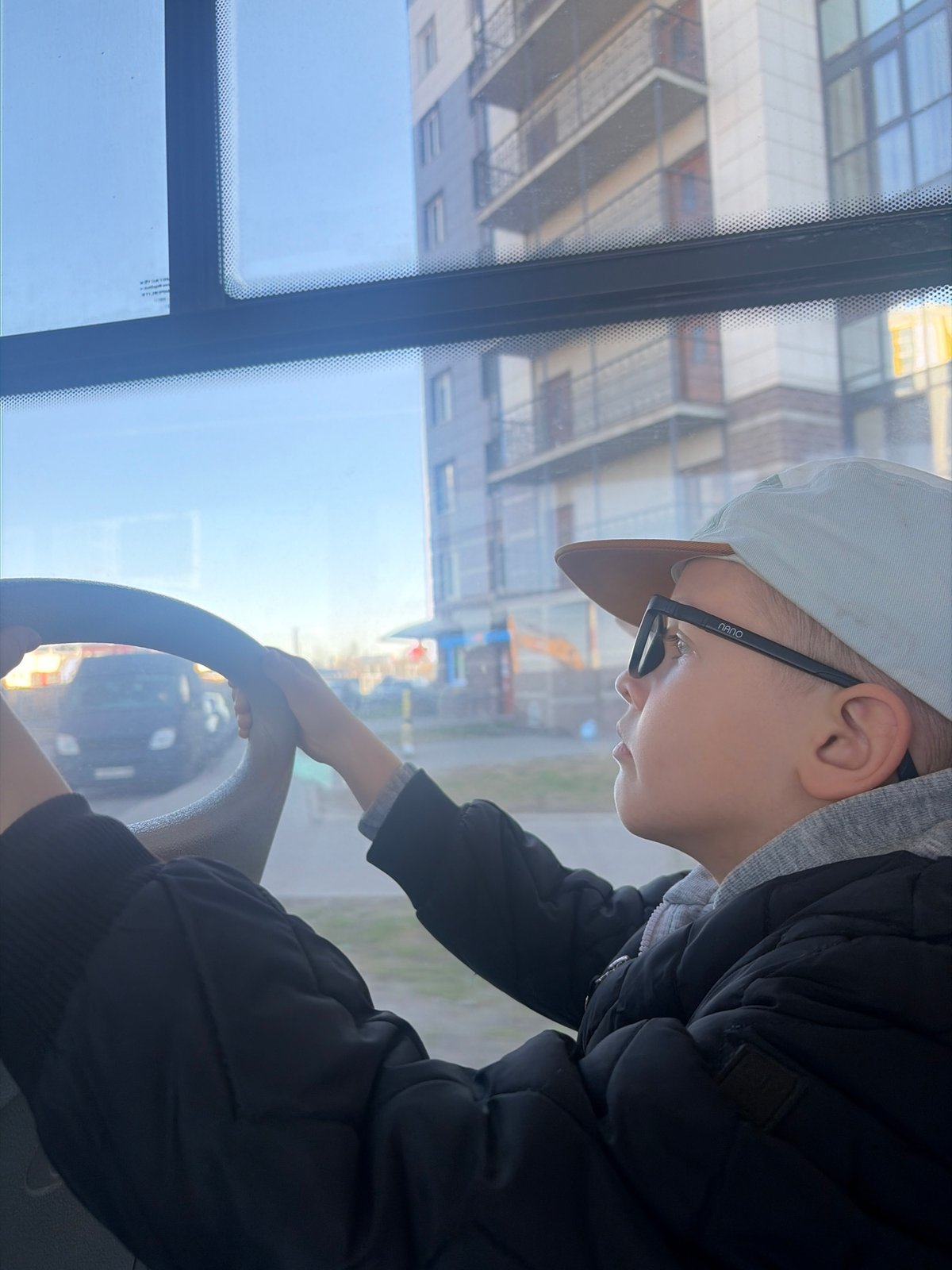 Child plays pretend driver in Saint Petersburg public transit vehicle