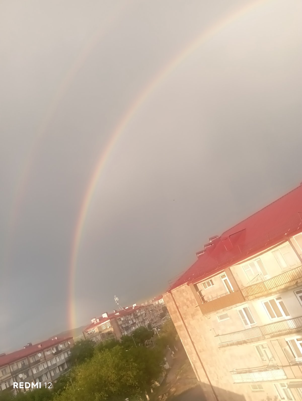 Double rainbow appears over residential Vedi, Armenia