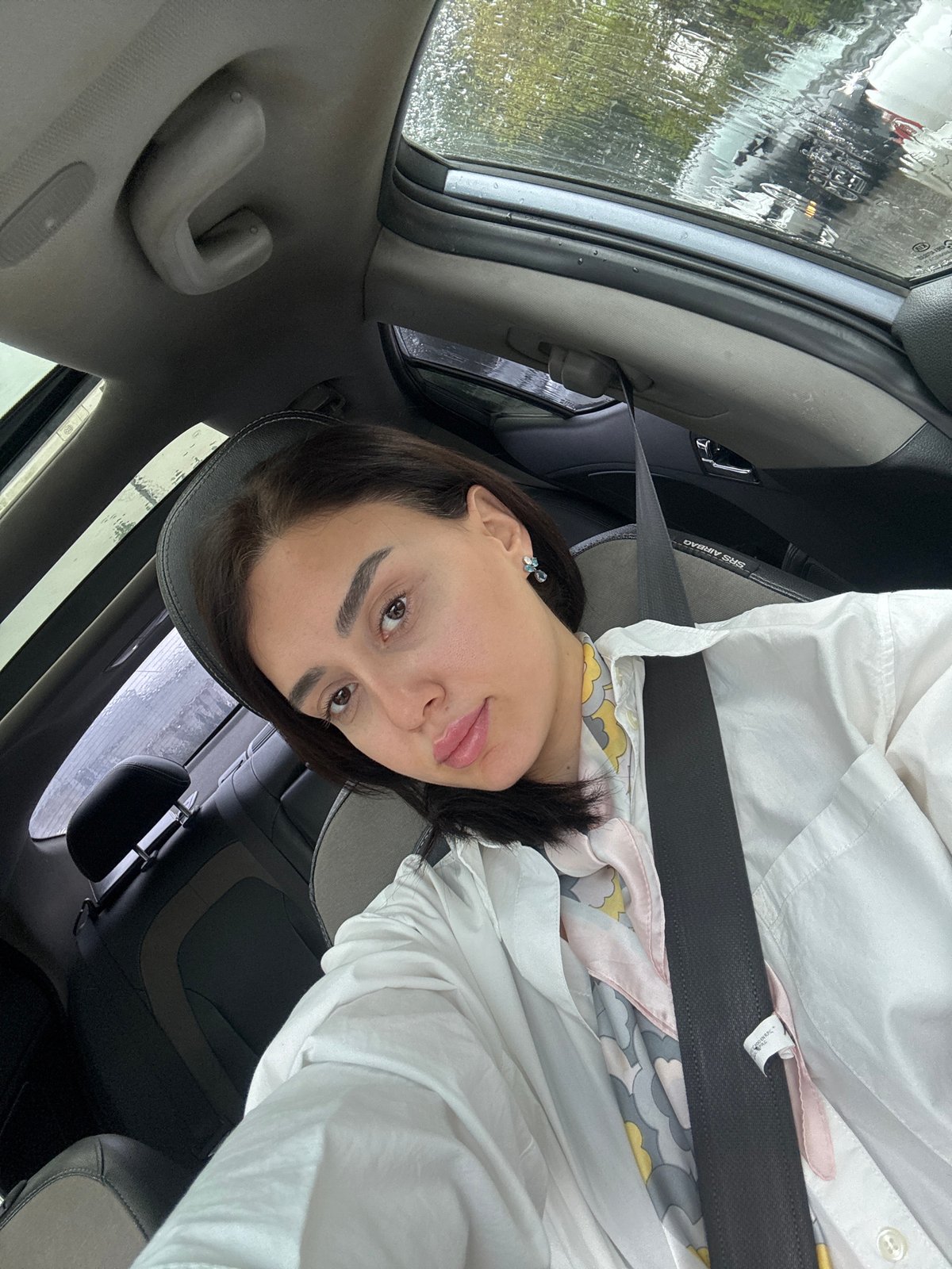 Woman drives through heavy morning rainfall in Tbilisi