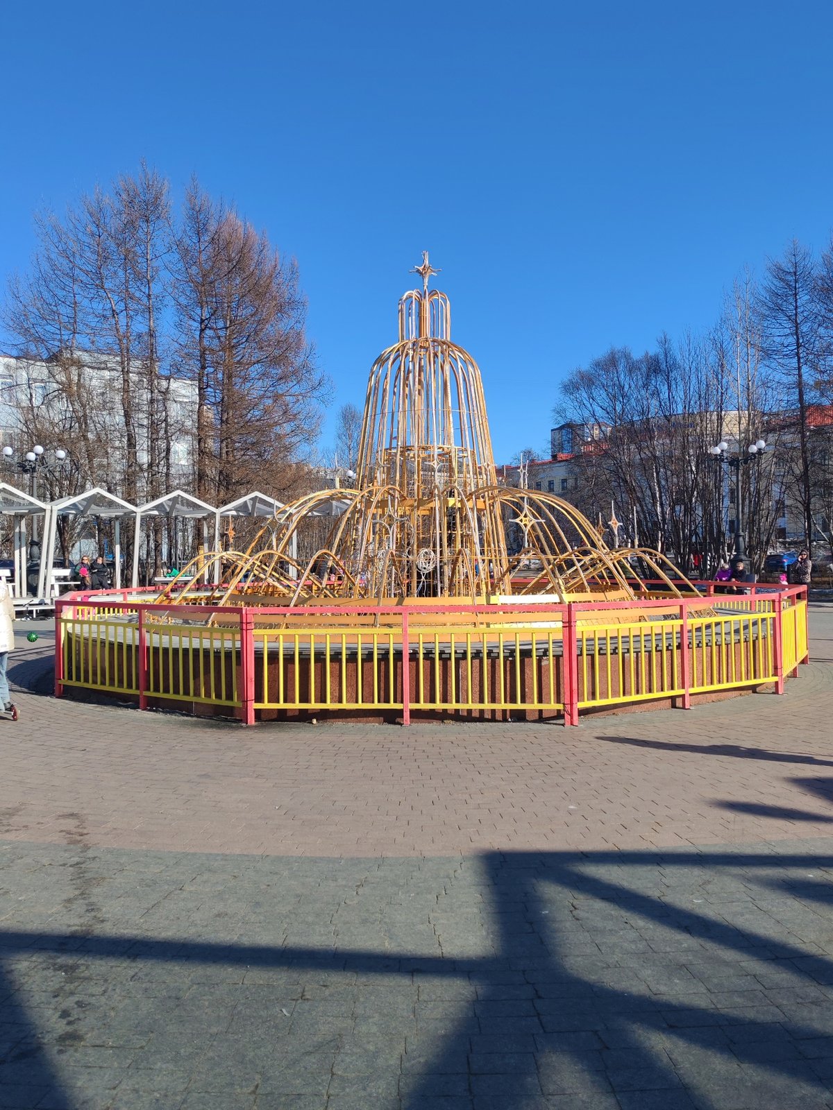 Sunny day fountain scene captured in Murmansk public square