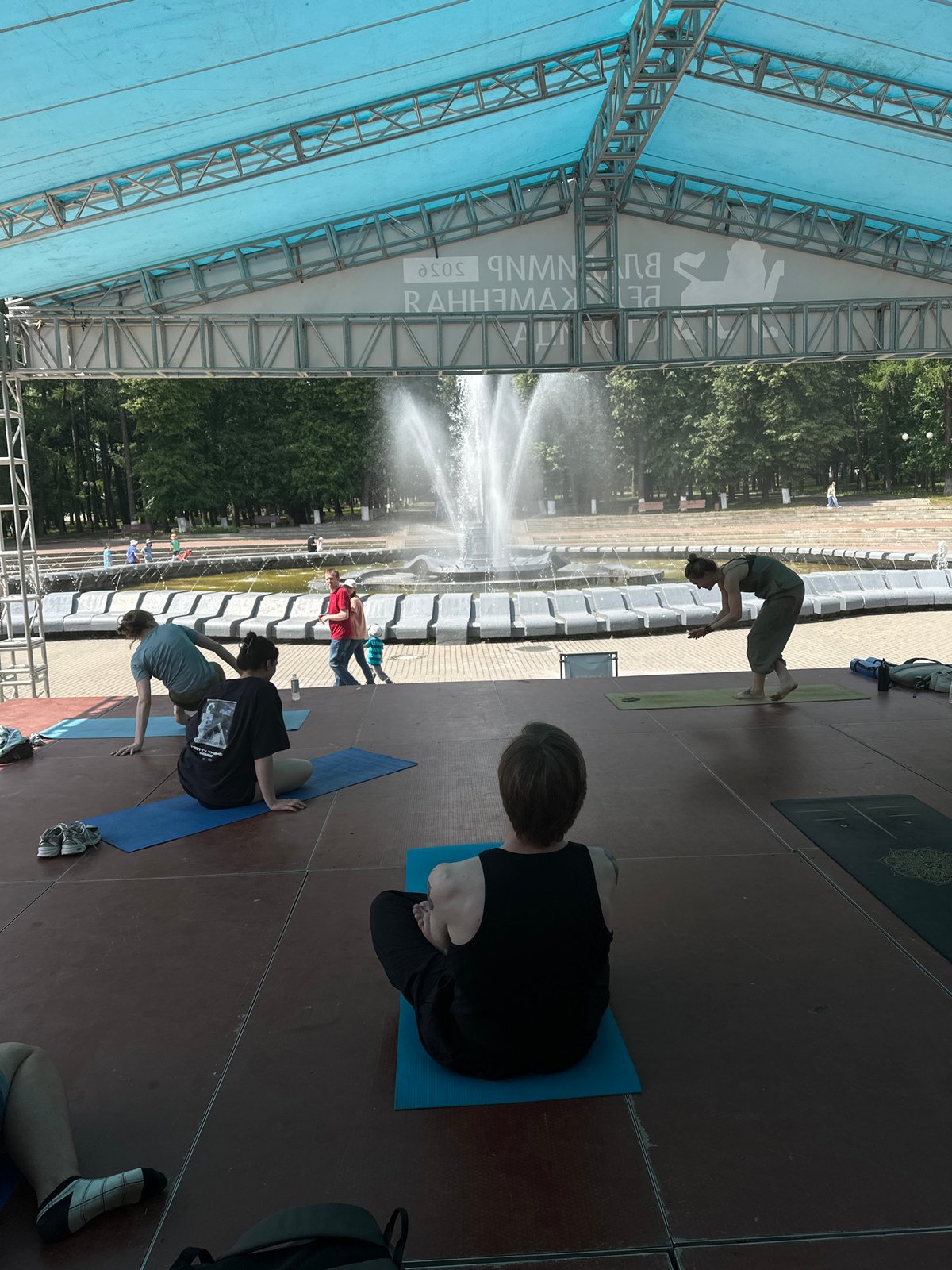 Outdoor yoga session on stage in Vladimir public square