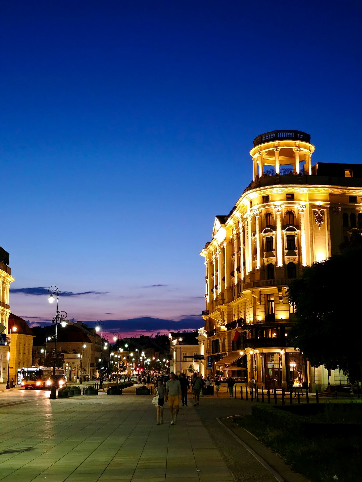 Warsaw at dusk: pedestrian walkway and ornate historic facade