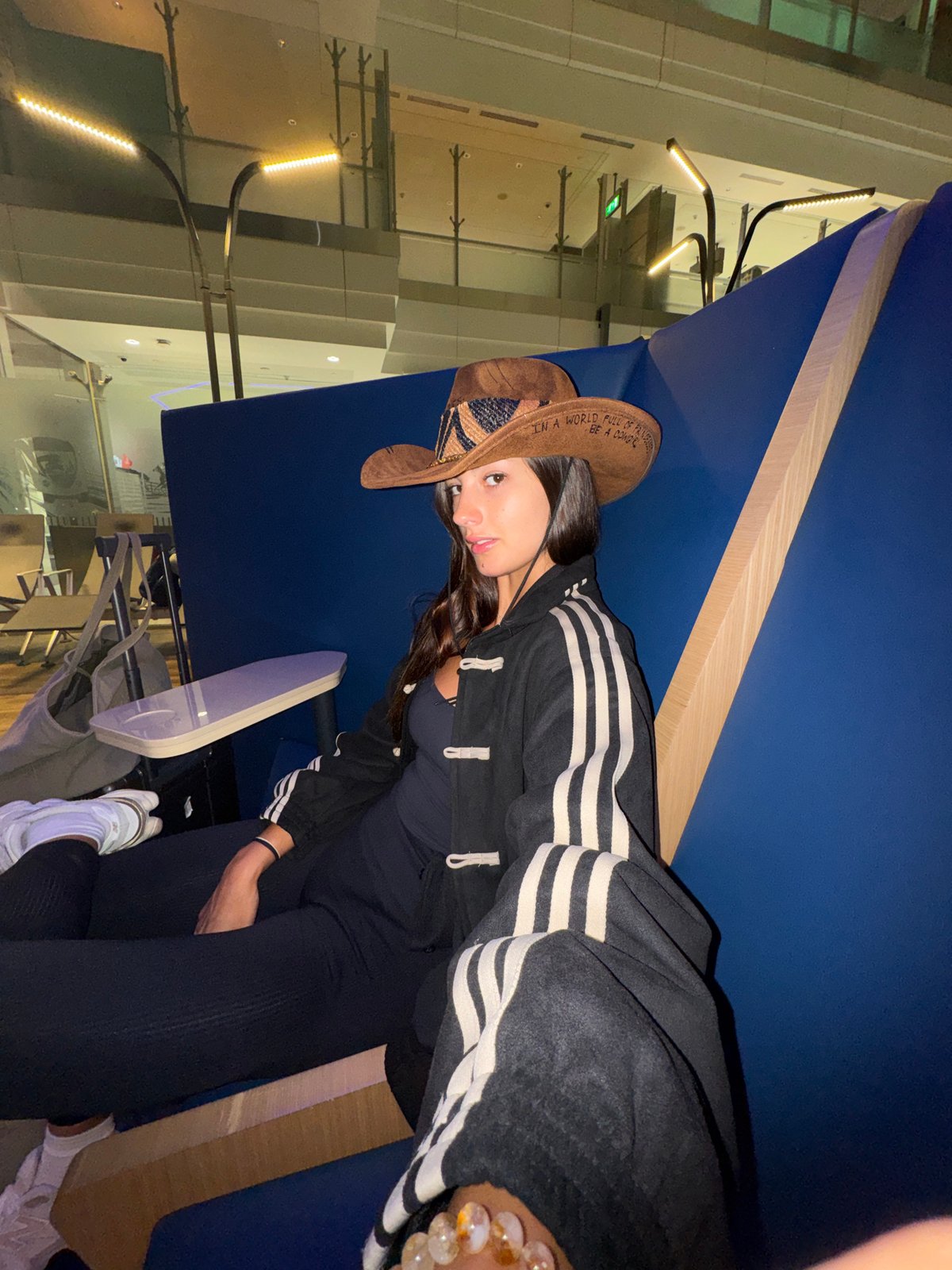 Cowboy hat and Adidas jacket in a Dubai lounge