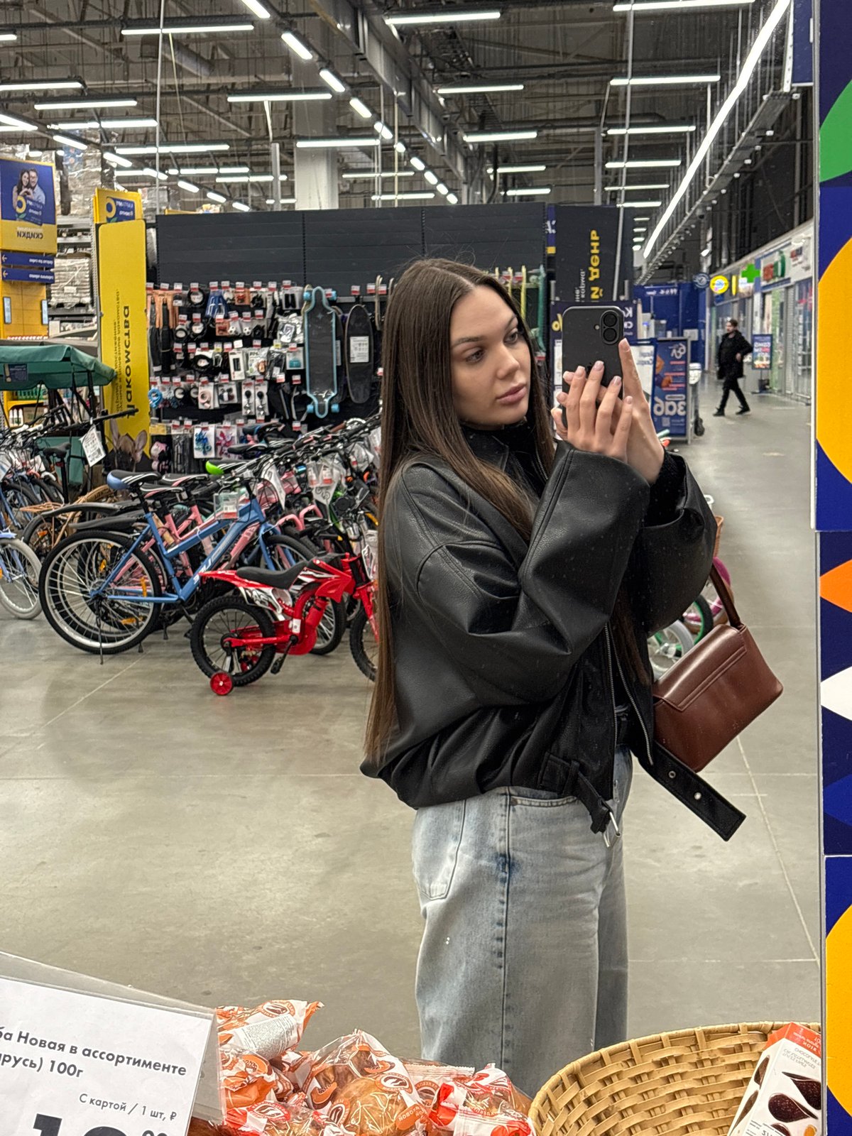 Woman takes mirror selfie in Yekaterinburg retail store