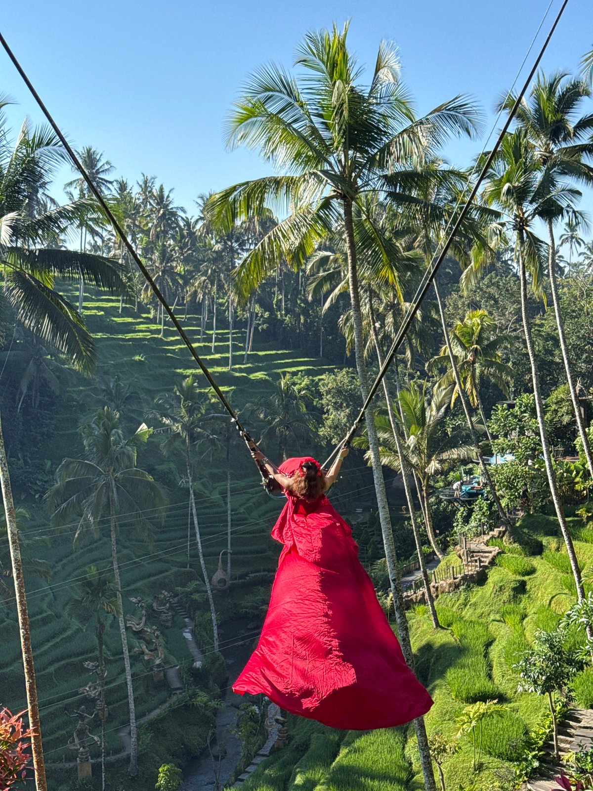 Red dress swing shoot over Tegallalang's rice terraces, Bali