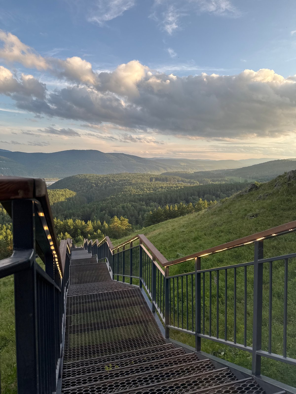 Metal staircase drops into forested valley near Krasnoyarsk