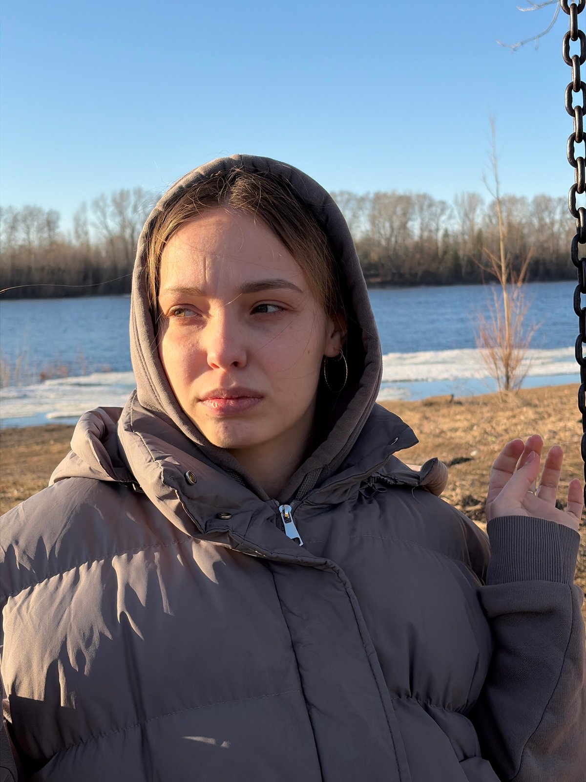 Woman documents spring afternoon along Kama River in Chaikovsky