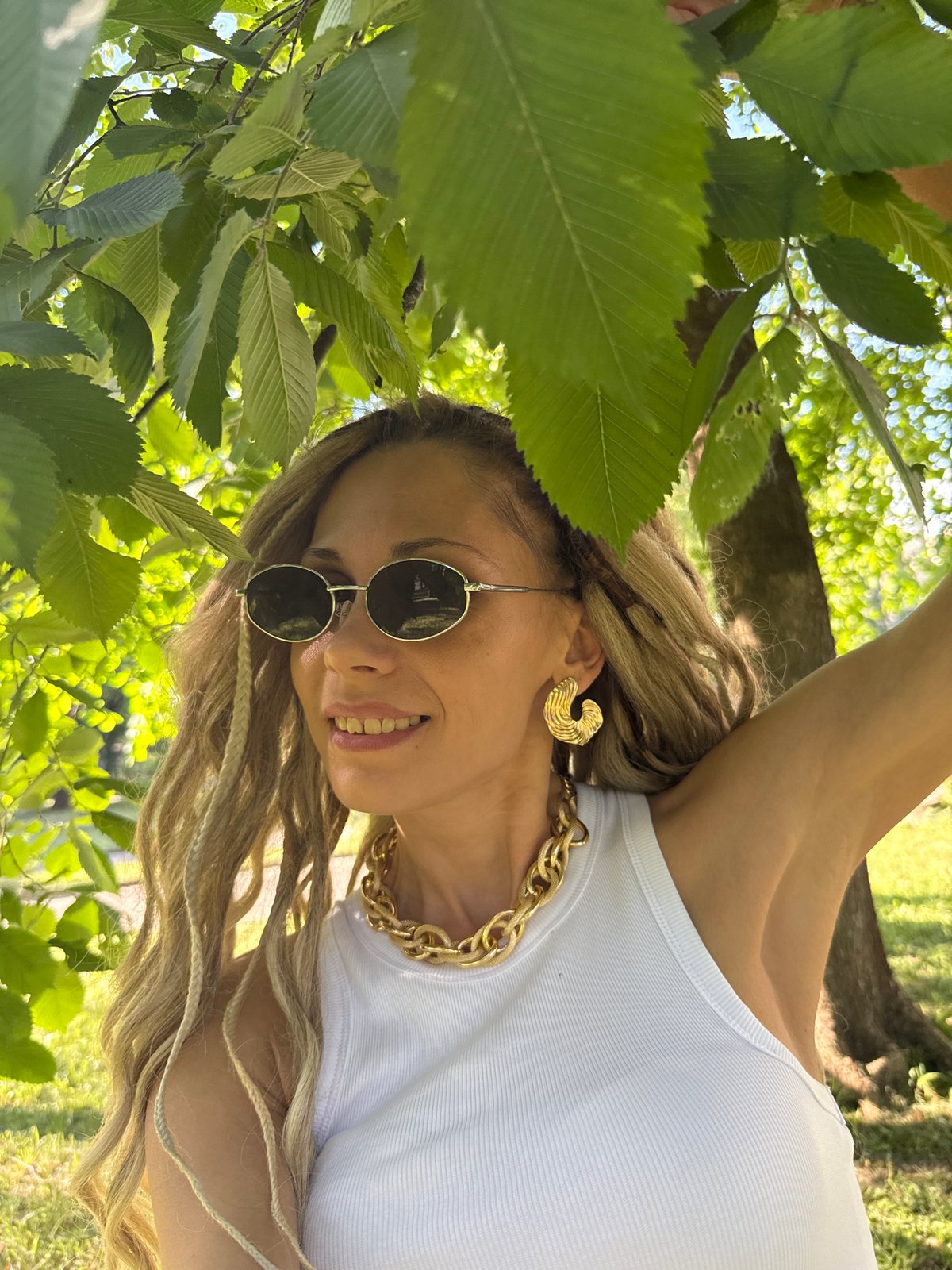 Woman takes selfies in sunny Rusanovo park