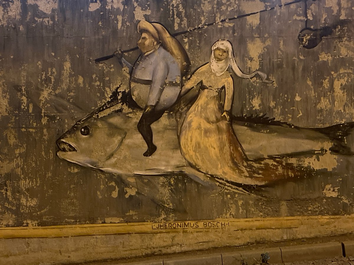 Odesa waterfront at night: murals, modern towers, and seaside dining