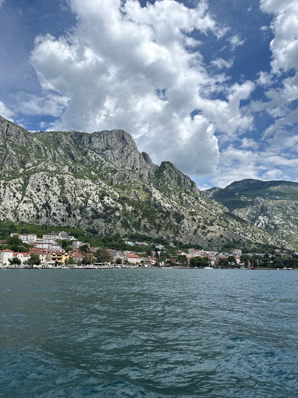 Coastal church and mountain views documented in Dobrota, Montenegro