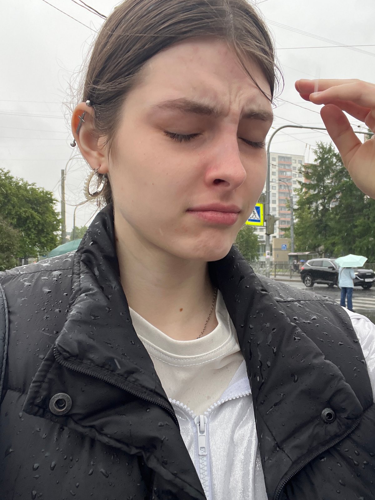 Person walks through rainy Saint Petersburg streets during morning downpour