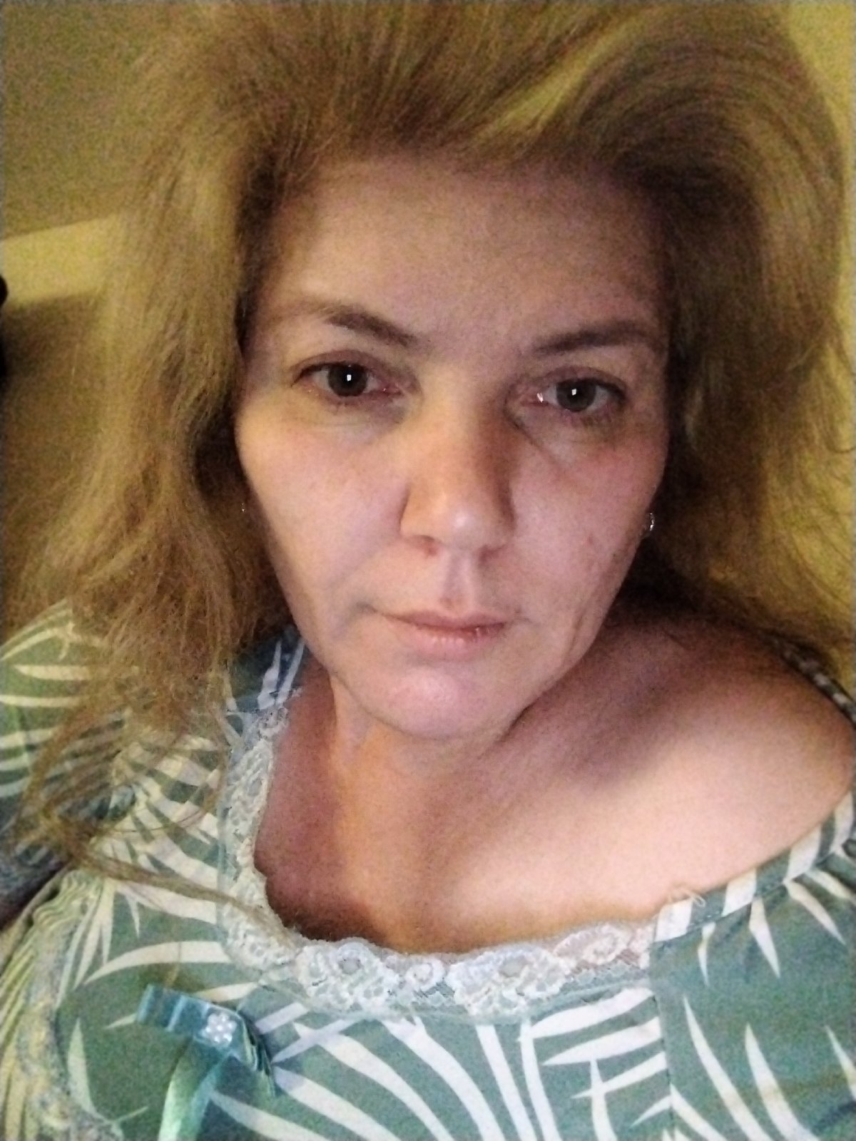 Woman photographed in multiple poses in UAE bedroom setting