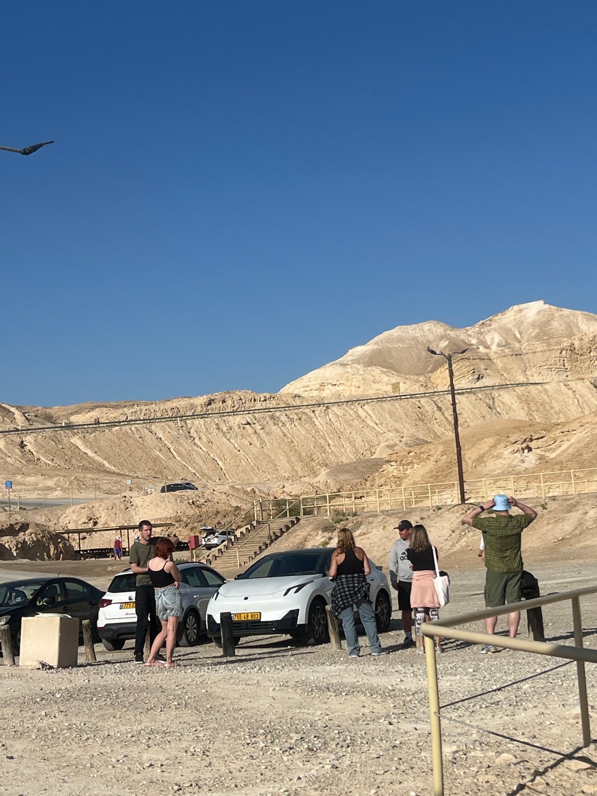 Early morning hikers gather on rocky mountainside in Israel