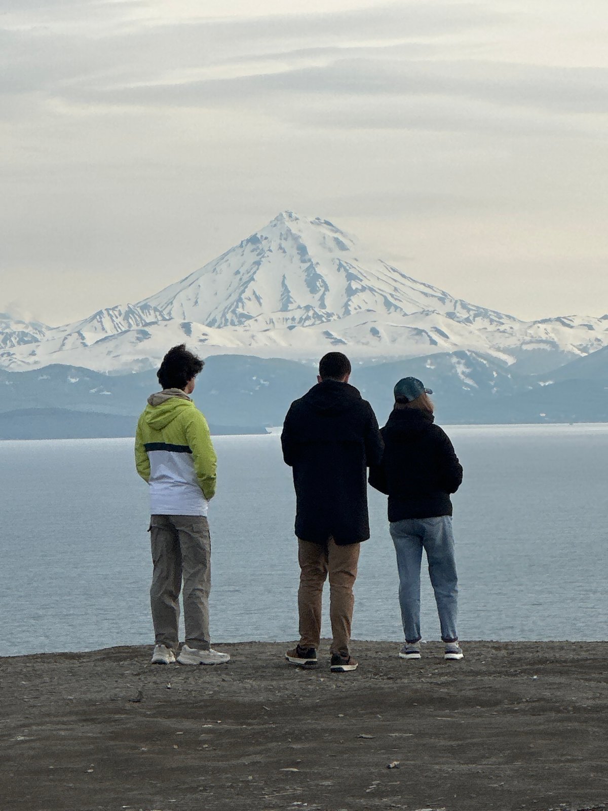 Rocky coastal overlook facing Avacha Bay and Kamchatka's volcanic peaks