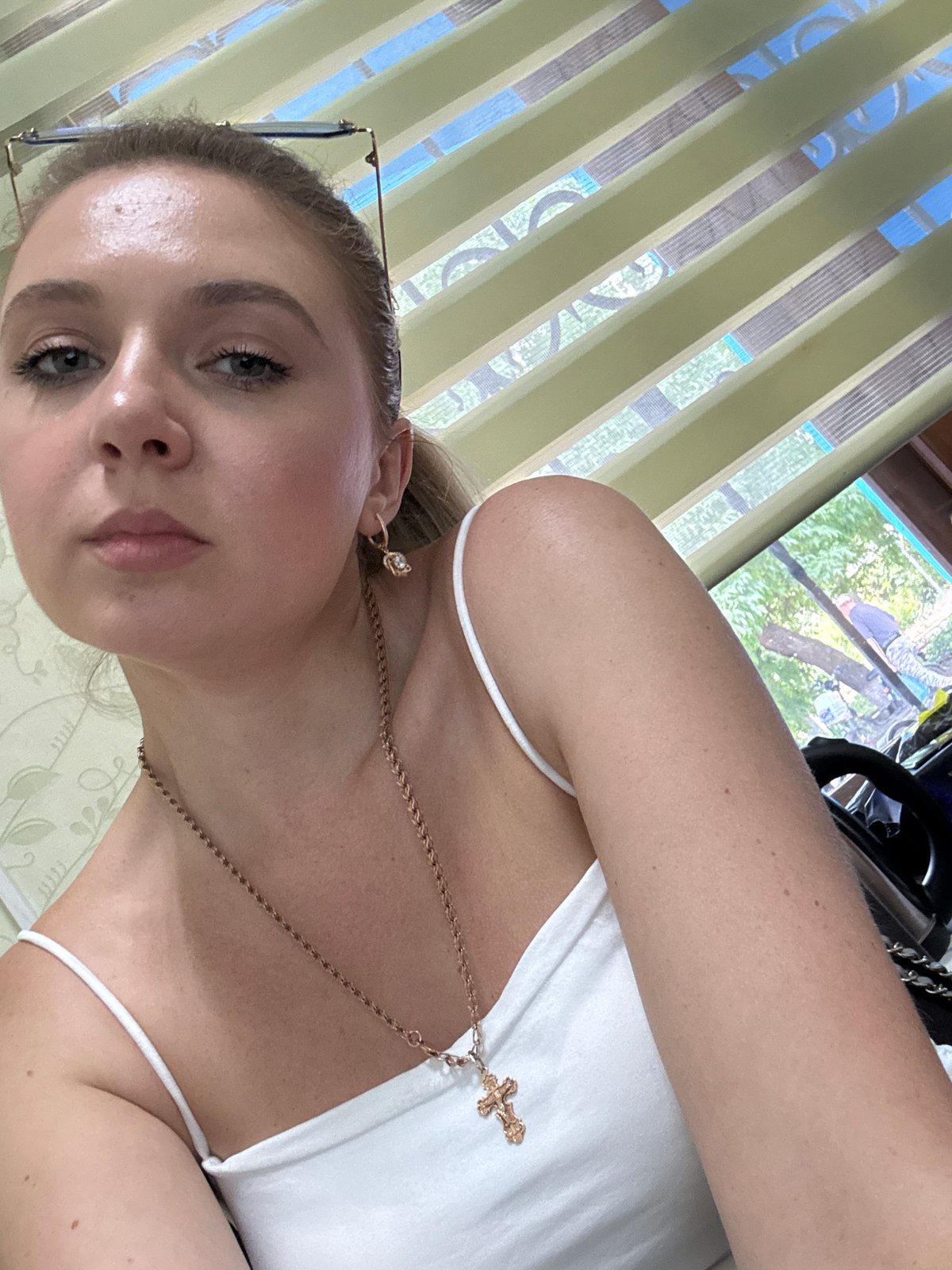 Indoor selfie session, white tank top and gold cross necklace