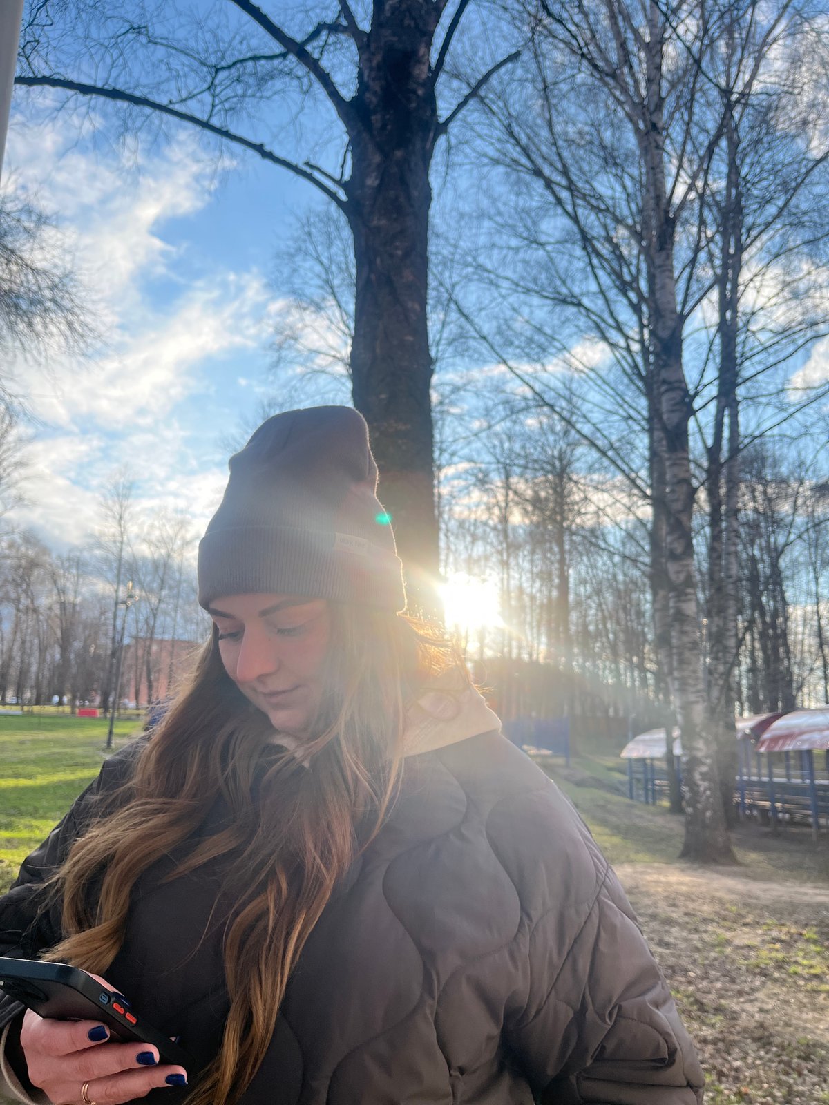 Woman takes selfies at park and waterfall in Klin
